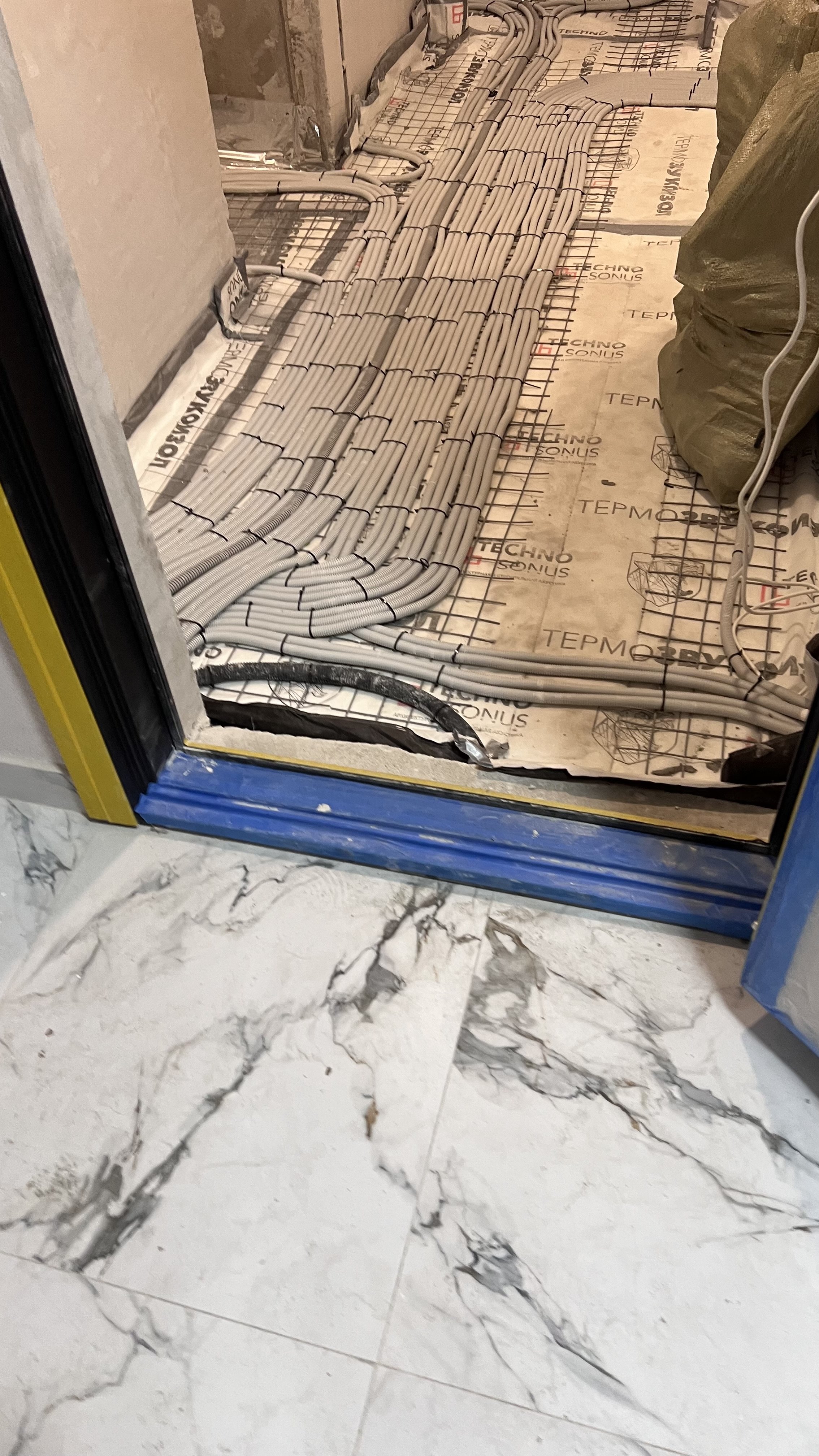 Электромонтажные работы: прокладка кабелей в гофротрубах на полу с теплоизоляцией.